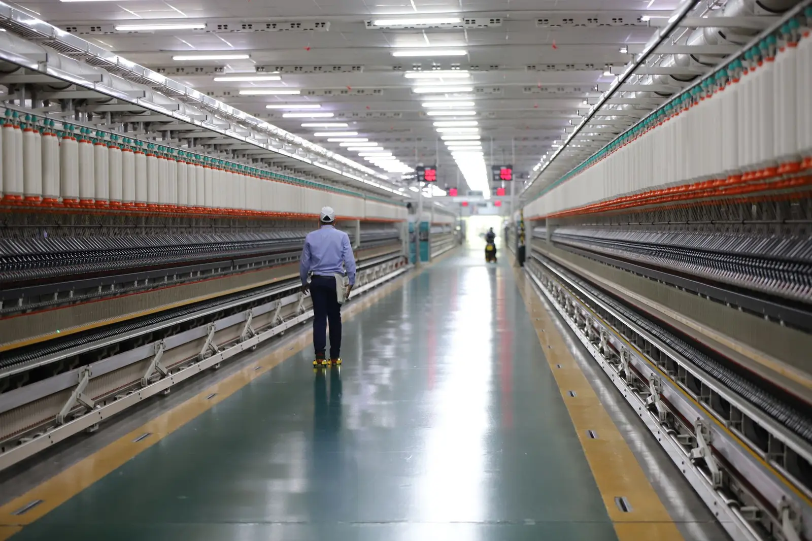 Worker on a manufacturing plant floor.