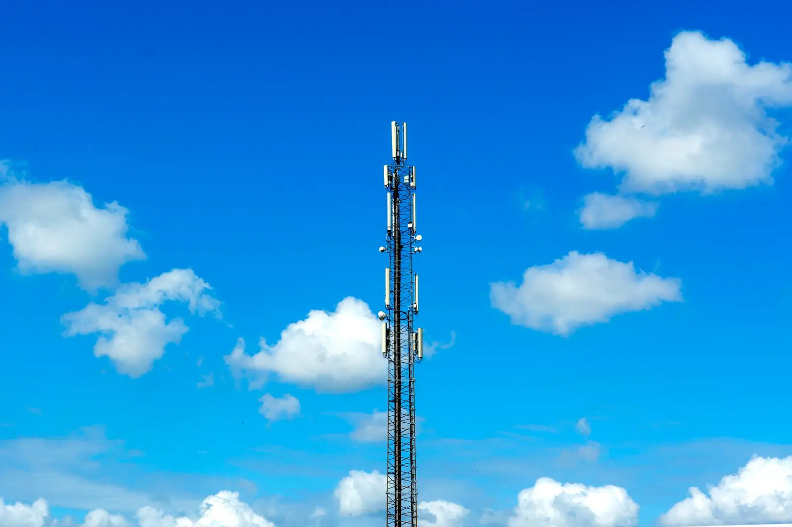 Telecom tower against a clear blue sky.