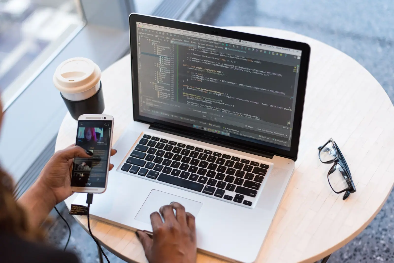 Programmer typing code on a laptop.