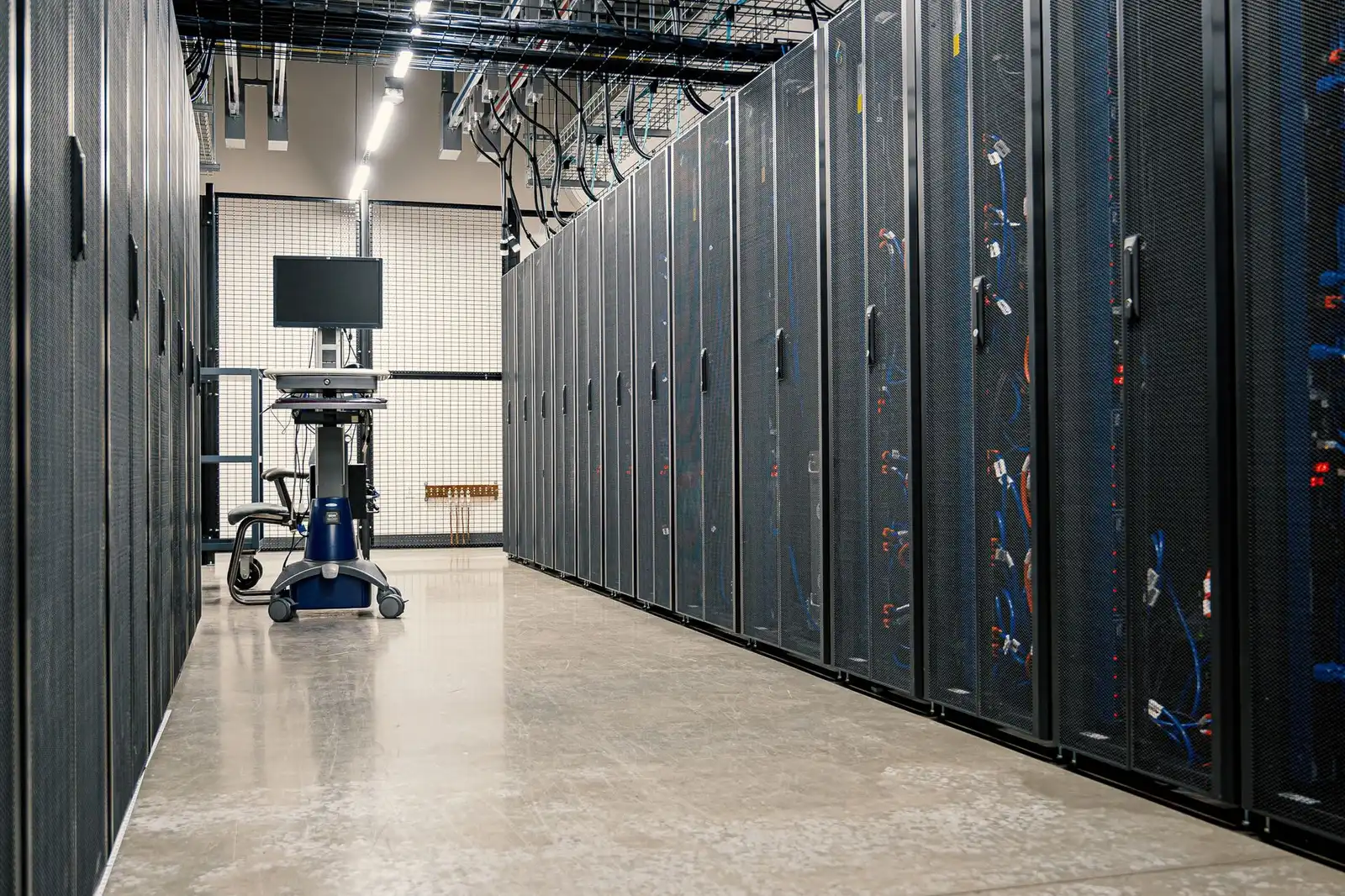 Close-up of a blue-lit server rack in a data center.
