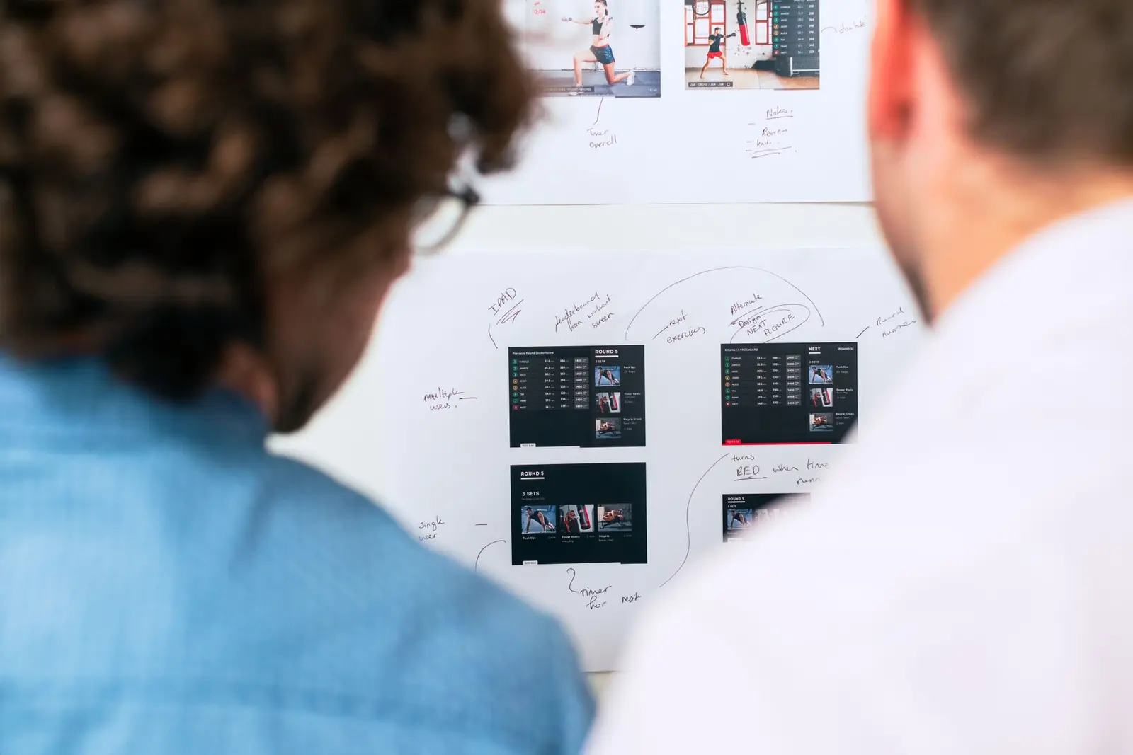 Two developers working at monitors in a modern office.